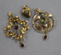 An Edwardian gold openwork pendant set amethyst and pearl, a peridot set pendant and a 15ct gold and
