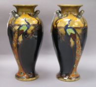 A pair of Thomas Forester Phoenix Ware vases with peacock decoration height 33cm