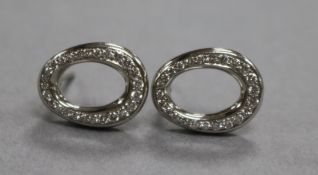 A modern pair of platinum and diamond set openwork oval ear studs, 13mm.
