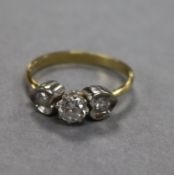 An 18ct gold and three stone diamond ring, size N.