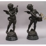 Two bronze sculptures of cherubs playing instruments, on marble bases tallest 32cm