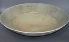 John Dunn (b. 1944), a very large raku bowl, in dusty pink and blue lustre crackle glaze,