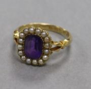 An early 20th century 18ct gold, amethyst and seed pearl dress ring, size M/N.
