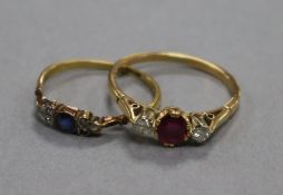 An 18ct gold, ruby and diamond three stone ring and a smaller 18ct gold, sapphire and diamond ring.