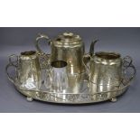 A plated engraved three piece teaset together with an oval plated tea tray tray length 49.5cm (4)