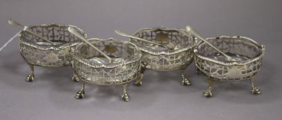 A set of four George II oval silver salts, London 1755, together with four silver salt spoons with