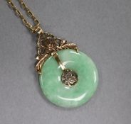 A Chinese yellow metal and jadeite disc pendant, on a yellow metal chain, pendant 8mm.