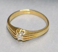 An 18ct gold and claw set solitaire diamond ring, size R.