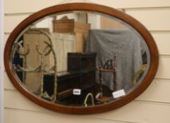 An Edwardian banded oval mirror W.77cm