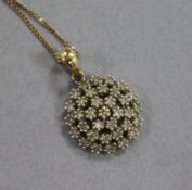 A 9ct gold and diamond cluster pendant on a 9ct gold fine link chain, pendant overall 19mm.