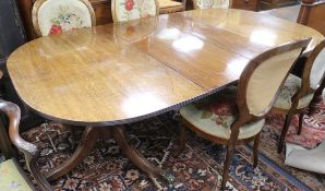 A Regency mahogany extending two pillar dining table, with one spare leaf W.200cm with leaf in