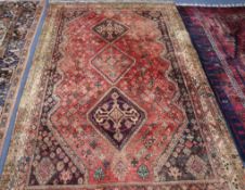 A Persian red ground rug 250 x 165cm