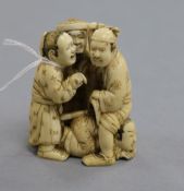 A Japanese ivory okimono carved with three figures height 6.5cm