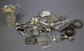 A group of mixed silver including a christening mug, vesta case, spoons etc.