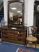 A Victorian ebonised and walnut chest, circa 1875, with matching wall mirror and side chair, the