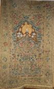 A Middle Eastern silk wall hanging, probably Iranian, featuring a peacock under an arch over a