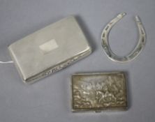 Two silver snuff boxes and a silver horseshoe.