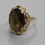 A 9ct gold and smoky quartz dress ring, decorative pierced mount, size O.