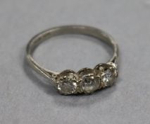 A platinum and three stone diamond ring, size M.