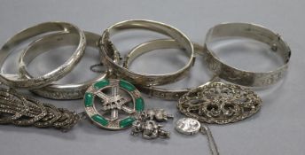 Five assorted silver bangles, three brooches including marcasite, a locket, a hardstone pendant