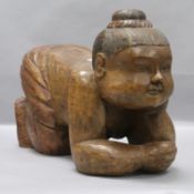 A carved hardwood figure of a kneeling lady length 49cm