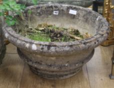 A large circular stone planter W.60cm