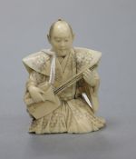 A Japanese netsuke of a figure playing biwa height 7cm