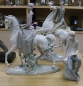 Three Lladro figures including horses and riders and a seated boy tallest 49cm