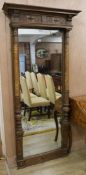 An Arts and Crafts rectangular full length wall mirror after the Regency manner with frieze
