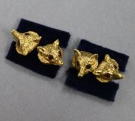 A pair of yellow metal and gem set fox head cufflinks.