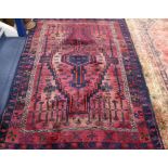A Persian red ground rug 220 x 153cm