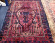 A Persian red ground rug 220 x 153cm