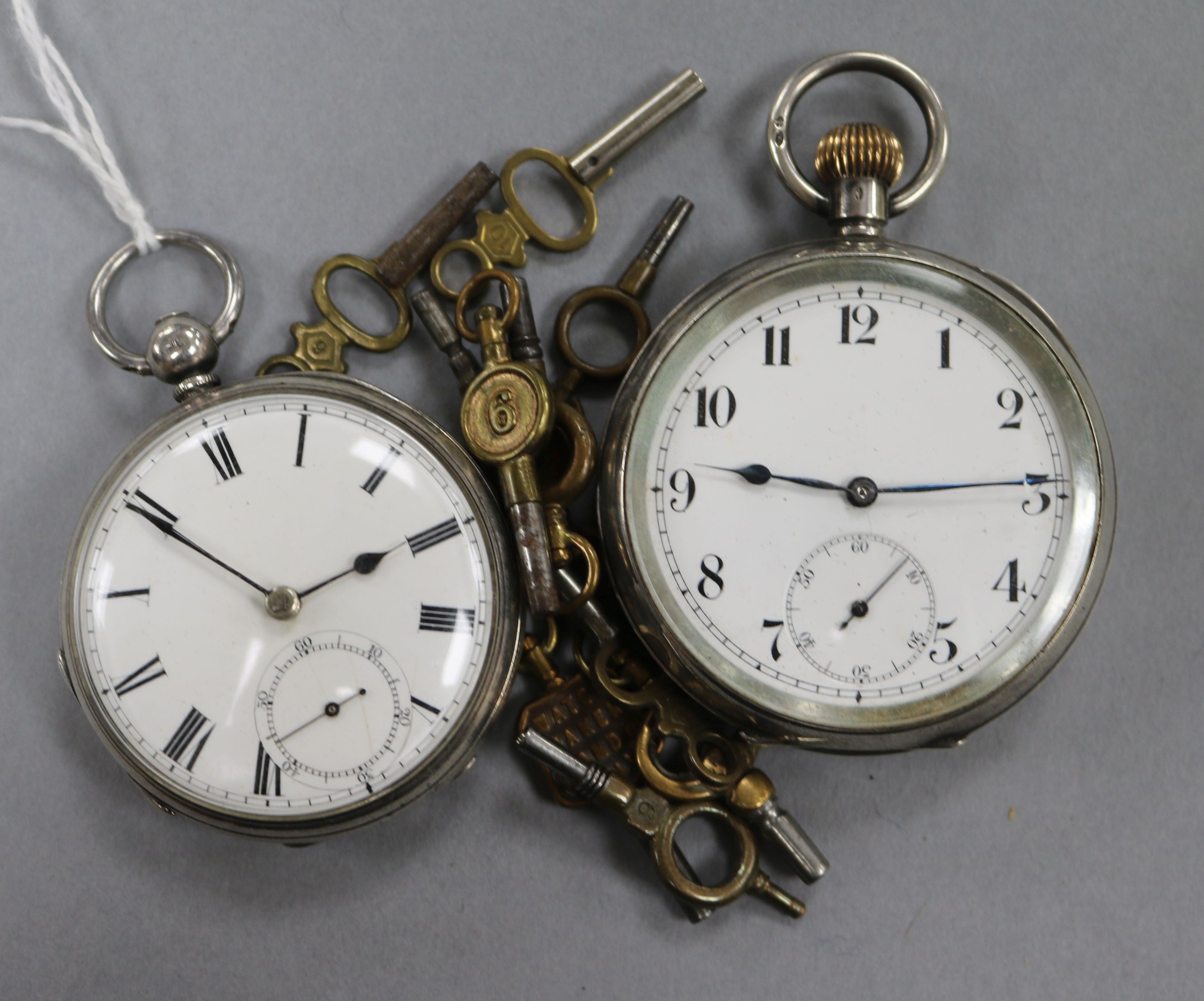 Two silver pocket watches and ten assorted watch keys.