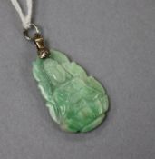 A white metal mounted carved jadeite pendant, 30mm.