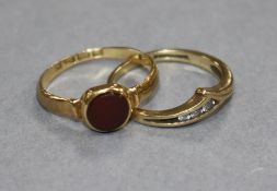 A late Victorian 18ct gold and carnelian signet ring and a 9ct gold and gem set ring.