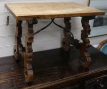 A Spanish walnut occasional table,19th century, on carved end supports united by wrought iron