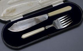 A cased pair of George V ivory handled silver fish servers, Sheffield, 1912.