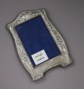 An Art Nouveau silver mounted photograph frame, with a floral embossed border, Birmingham, 1909,