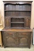 A 1920's oak dresser with plate rack over W.120cm