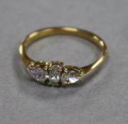 An 18ct gold and three stone diamond ring, set with pear and marquise cut stones, size K.