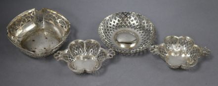 A pair of Edwardian pierced silver two handled bonbon dishes, Birmingham, 1909 and two other