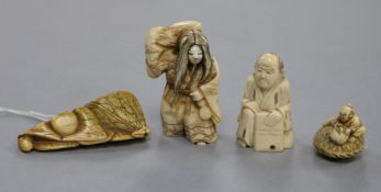A Japanese carved ivory netsuke of a woman carrying a bundle, a netsuke formed of stylised fruit and