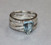 A modern 18ct white gold, aquamarine and diamond set dress ring, size K.