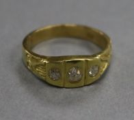 An 18ct gold and three stone diamond ring, size M/N.