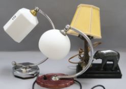 A 1930's chrome and white glass wall light and three desk lamps