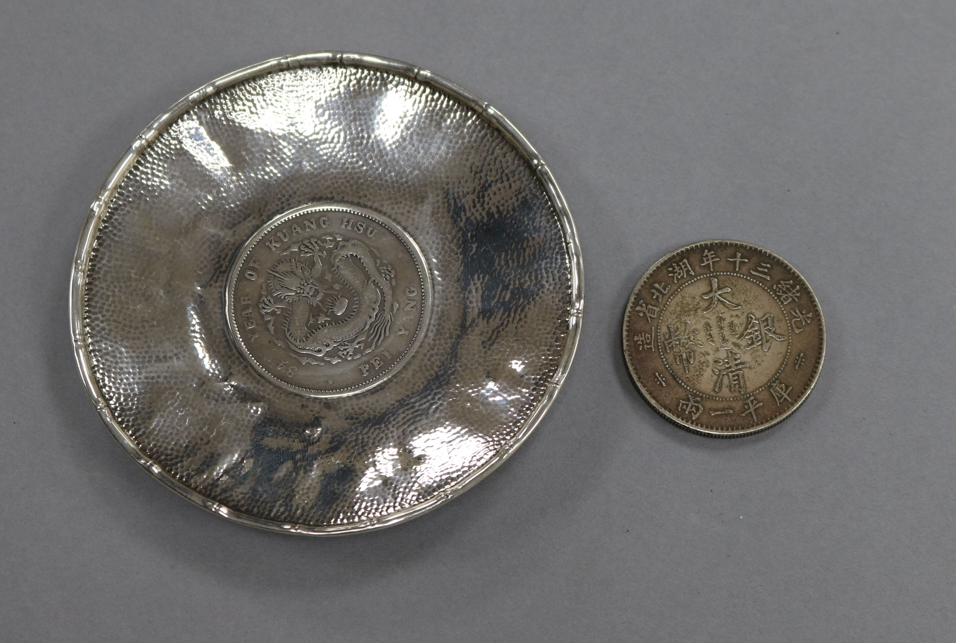 A coin inset tray and another coin