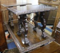 A suite of three Spanish carved walnut centre tables, 19th century, each having carved top with