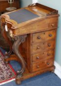 A Victorian walnut davenport, circa 1860, having galleried top and fitted interior enclosed by