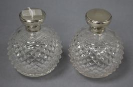 A pair of George V engine turned silver topped cut glass globular scent bottles, GW, London, 1920,