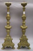 A pair of brass pricket candlesticks height 64cm